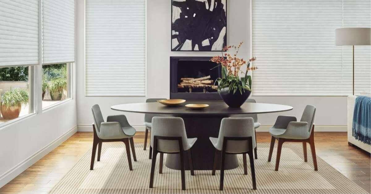 Modern dining room with elegant decor and window shades.
