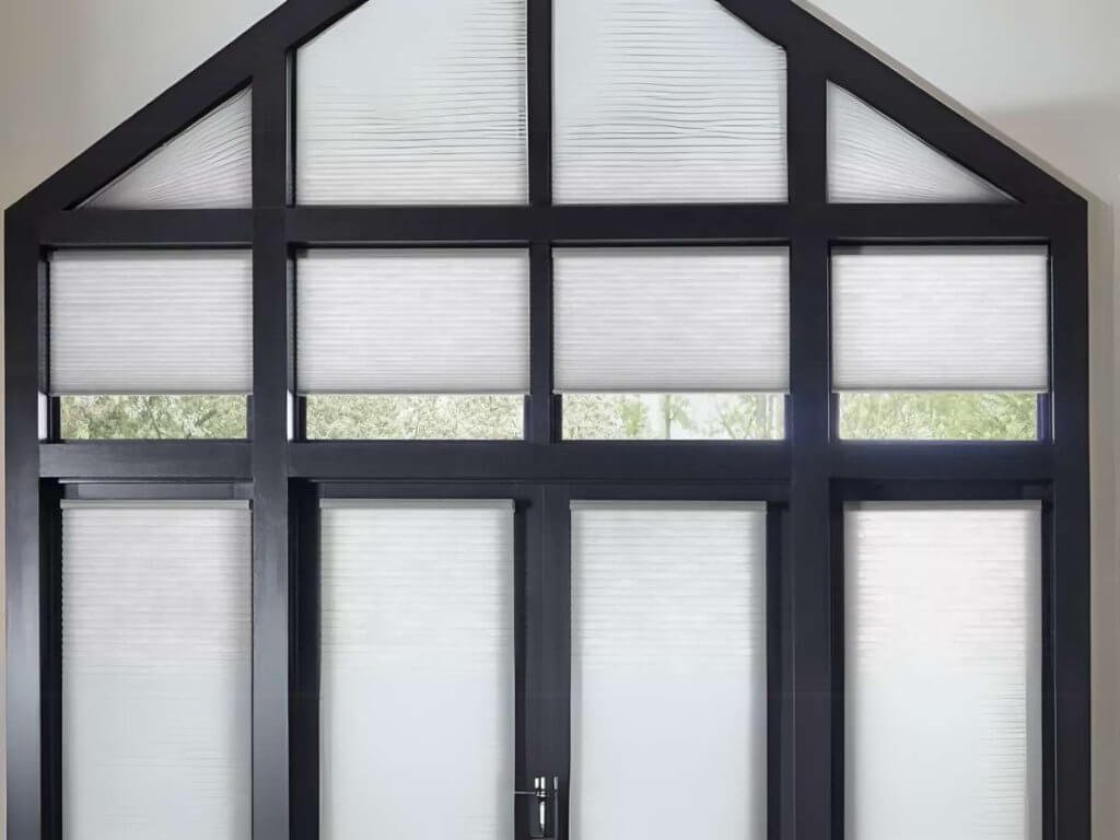 Cellular shades, also known as honeycomb shades, are an excellent option for angled and trapezoid windows due to their insulating ability while allowing light control.