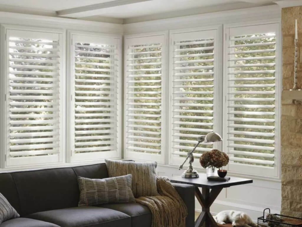 Hunter Douglas NewStyle Shutters in living room corner windows